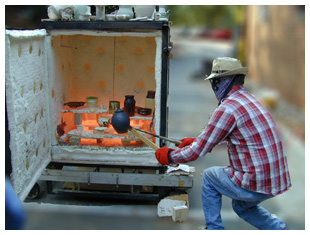 Conrad removing a pot from the raku kiln